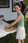 Sabrina Bovee cutting pizza