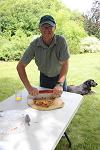 Bruce Neill cutting pizza